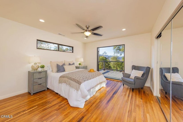 bedroom with hardwood / wood-style flooring, ceiling fan, a closet, and access to outside