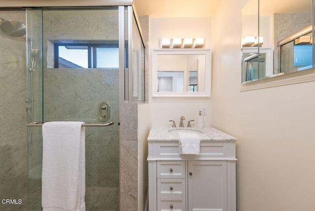 bathroom featuring vanity and an enclosed shower