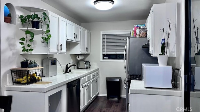 kitchen featuring sink, dark wood-type flooring, black dishwasher, white cabinets, and tile countertops