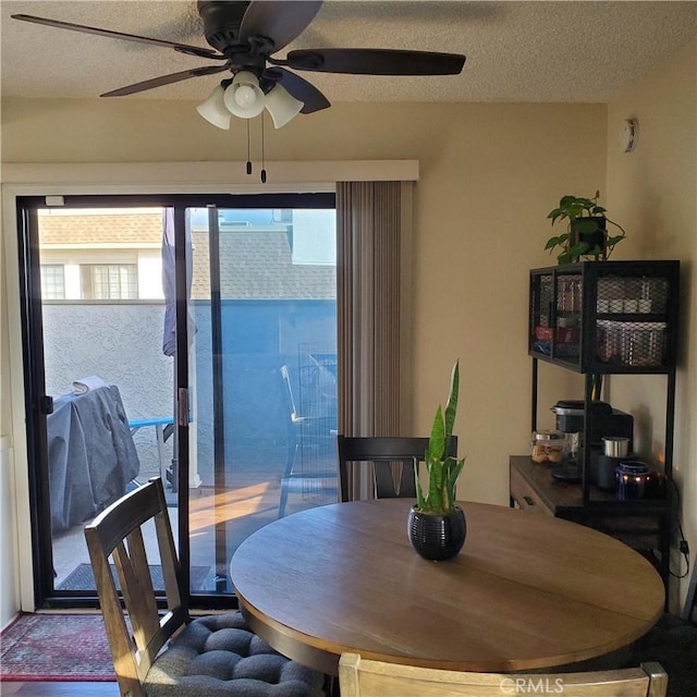 dining room with ceiling fan and a textured ceiling