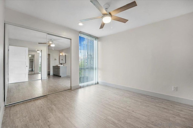 unfurnished room featuring ceiling fan and light hardwood / wood-style flooring