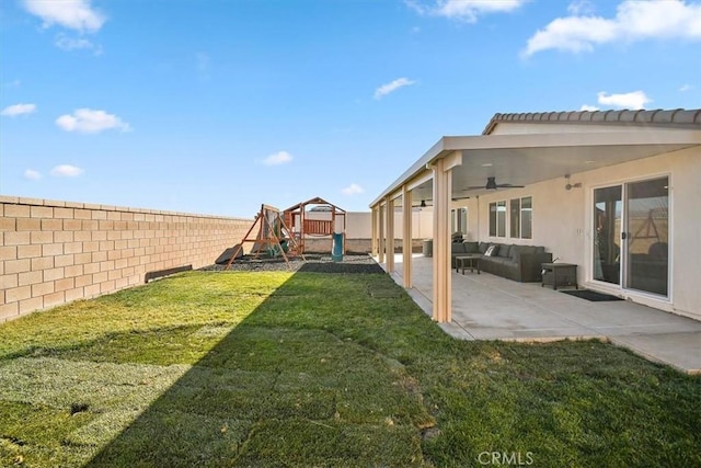 view of yard featuring a patio area, a fenced backyard, a ceiling fan, and a playground