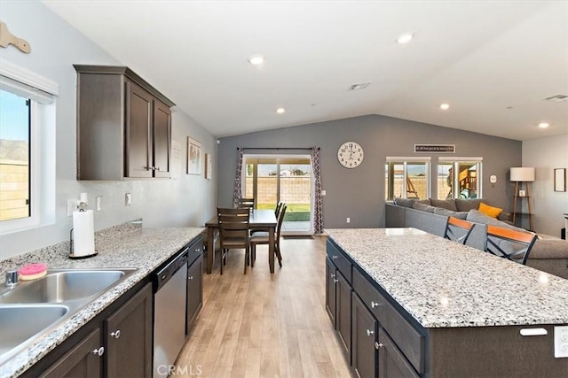 kitchen featuring light wood-style flooring, a sink, open floor plan, a center island, and dishwasher