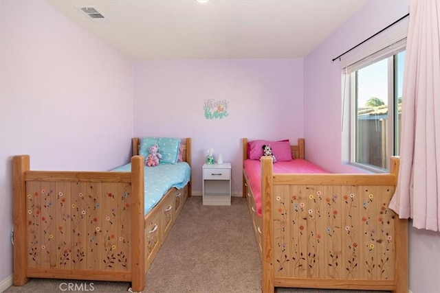 bedroom with baseboards, visible vents, and light colored carpet