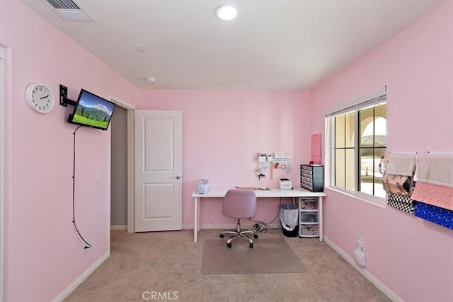 office area featuring baseboards, visible vents, and light colored carpet