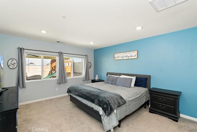 bedroom with light colored carpet, visible vents, baseboards, and recessed lighting