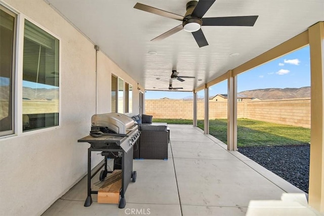 view of patio / terrace with a fenced backyard, a mountain view, area for grilling, and ceiling fan