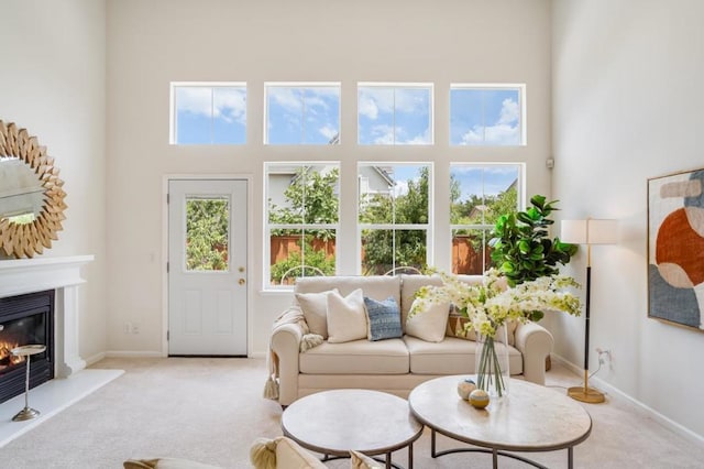 carpeted living room featuring a high ceiling