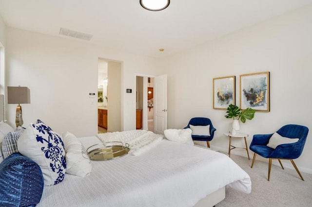 carpeted bedroom featuring ensuite bathroom