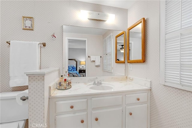 bathroom with ceiling fan, vanity, and toilet