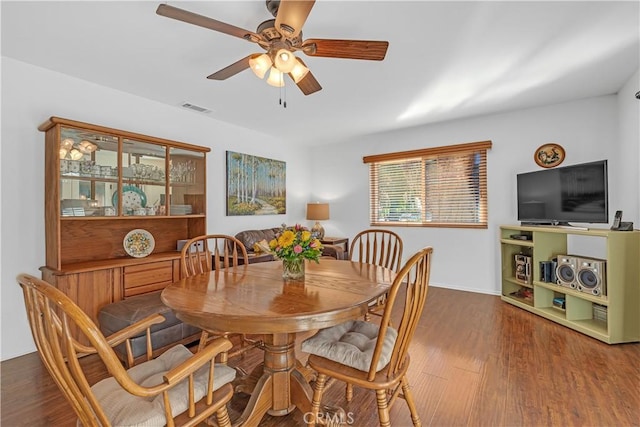 dining area with dark hardwood / wood-style floors and ceiling fan