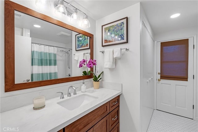 bathroom featuring vanity, tile patterned flooring, and a shower with curtain