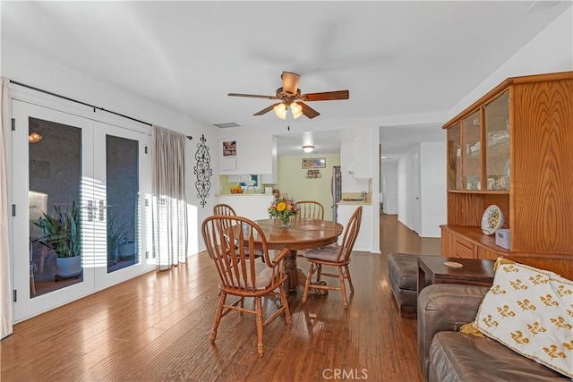 dining area with wood-type flooring and ceiling fan