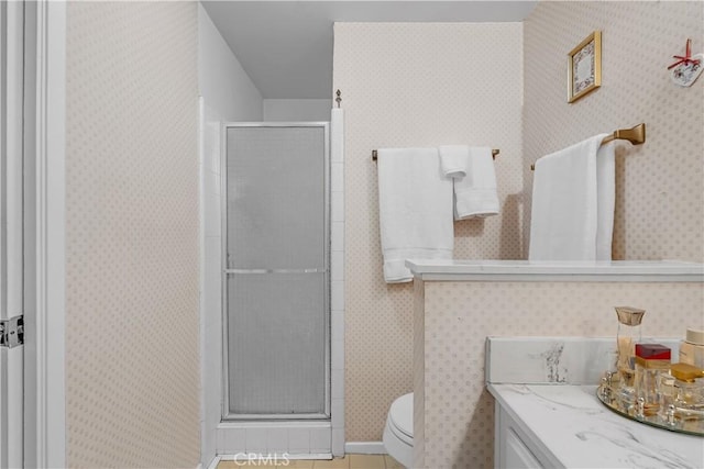 bathroom featuring vanity, an enclosed shower, and toilet