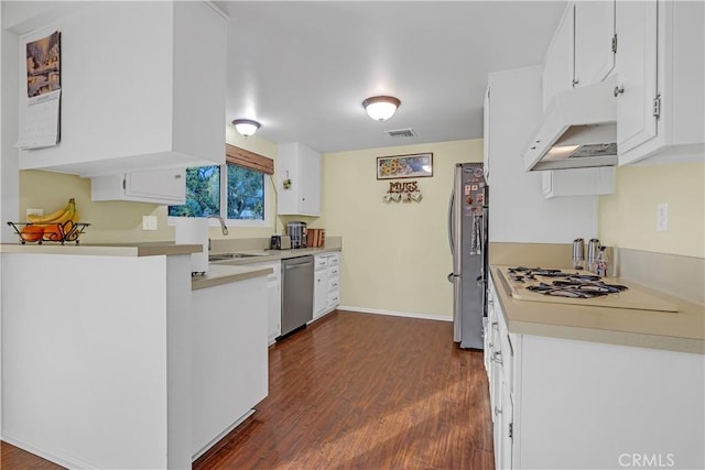 kitchen featuring stainless steel appliances, white cabinetry, sink, and dark hardwood / wood-style flooring