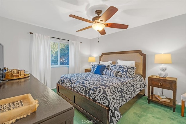 bedroom featuring ceiling fan and dark colored carpet