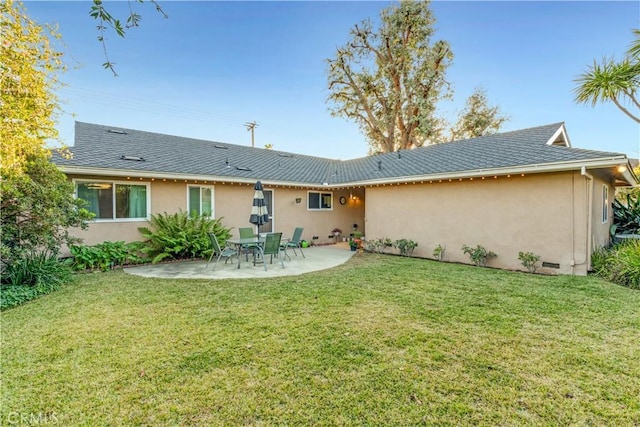 rear view of house featuring a yard and a patio