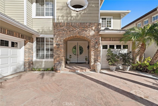 view of exterior entry featuring a garage