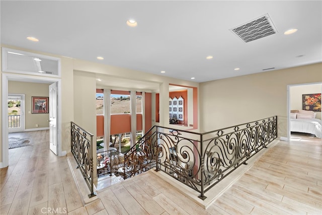 hallway featuring light hardwood / wood-style flooring and a wealth of natural light