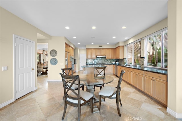 dining room featuring an inviting chandelier and sink