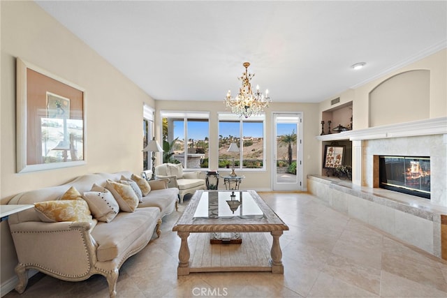 living room featuring a fireplace, built in features, and a notable chandelier