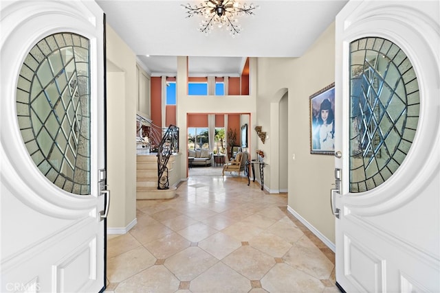 tiled entryway with an inviting chandelier