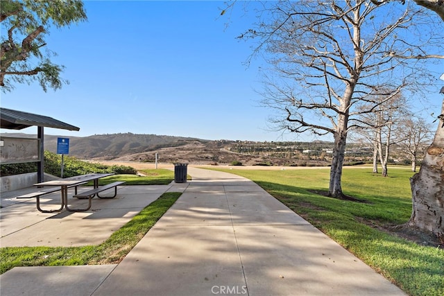 view of community featuring a mountain view and a lawn