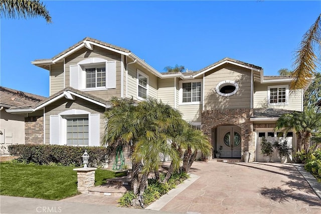 view of front of home with a garage and a front lawn