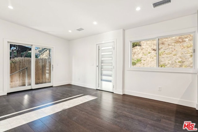 unfurnished room featuring dark hardwood / wood-style flooring