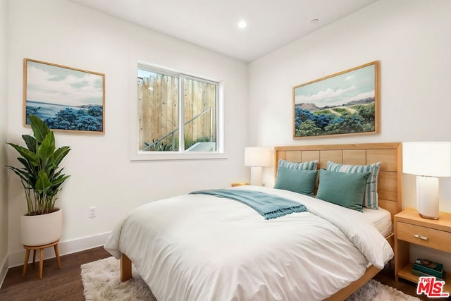 bedroom with dark hardwood / wood-style flooring