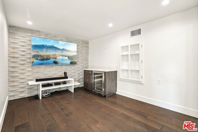 bar with wine cooler, dark hardwood / wood-style floors, and built in features