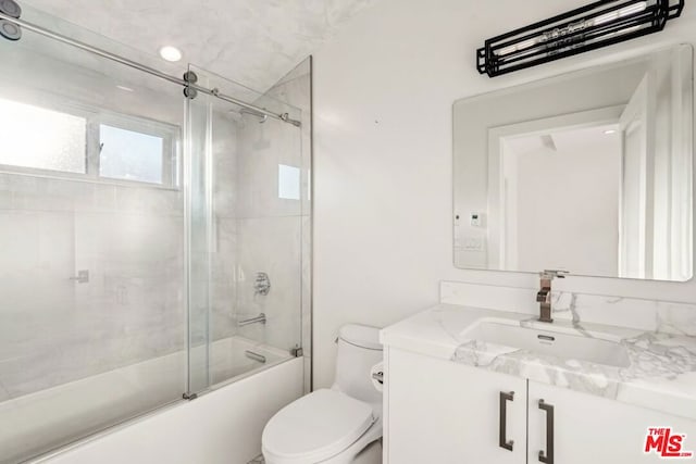 full bathroom featuring vanity, shower / bath combination with glass door, and toilet