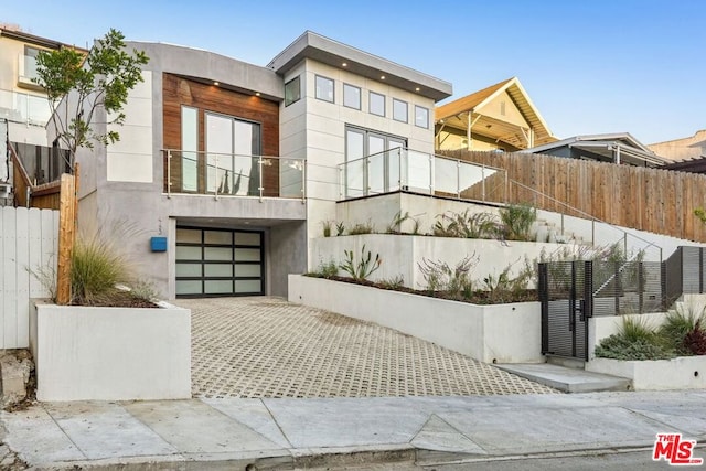 view of front facade featuring a garage and a balcony