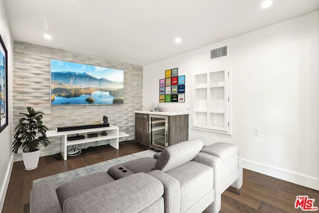 living room featuring dark hardwood / wood-style floors, built in features, beverage cooler, and indoor bar