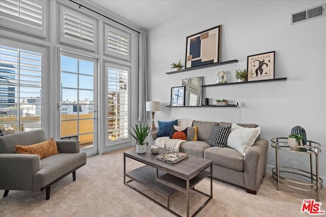 carpeted living room featuring a wall of windows, plenty of natural light, and a high ceiling