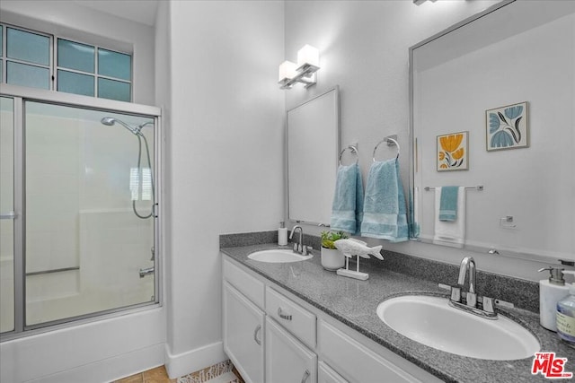 bathroom featuring enclosed tub / shower combo, vanity, and tile patterned flooring