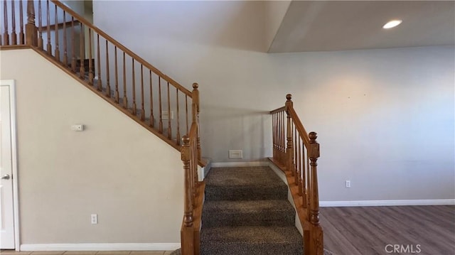 stairs with hardwood / wood-style floors