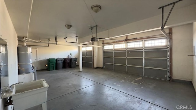 garage with a garage door opener and secured water heater