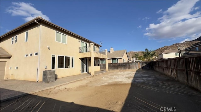 back of house featuring central AC unit