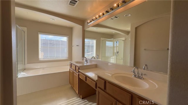 bathroom with vanity and separate shower and tub