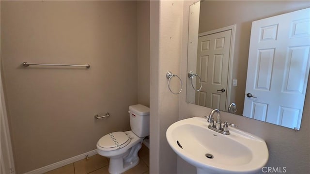 bathroom featuring sink, tile patterned floors, and toilet