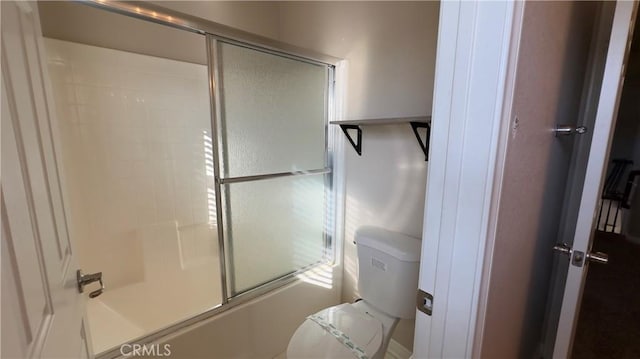 bathroom with enclosed tub / shower combo and toilet