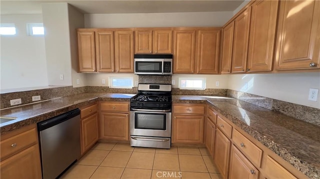 kitchen featuring appliances with stainless steel finishes and light tile patterned floors