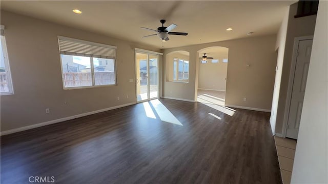 spare room with dark wood-type flooring and ceiling fan