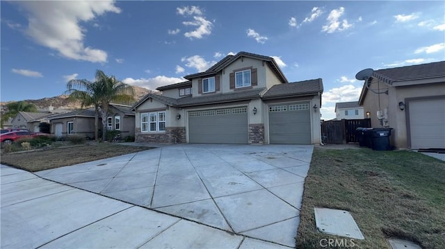 view of front of home with a garage and a front lawn