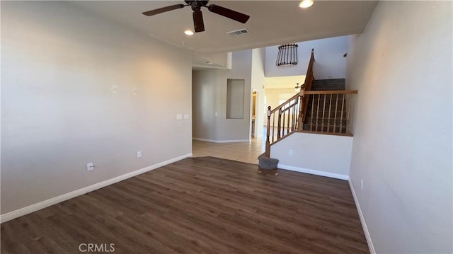 empty room with ceiling fan and dark hardwood / wood-style floors