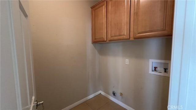 laundry room featuring tile patterned floors, gas dryer hookup, cabinets, washer hookup, and hookup for an electric dryer