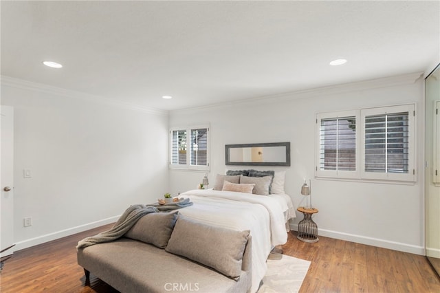 bedroom with ornamental molding and wood-type flooring