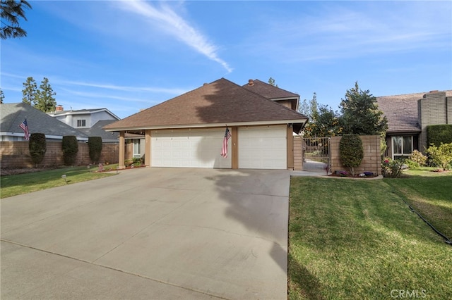 view of front of property featuring a garage and a front yard