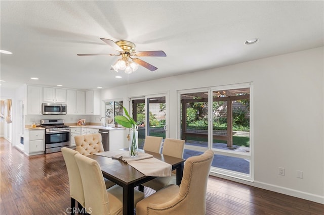 dining space featuring ceiling fan and dark hardwood / wood-style floors